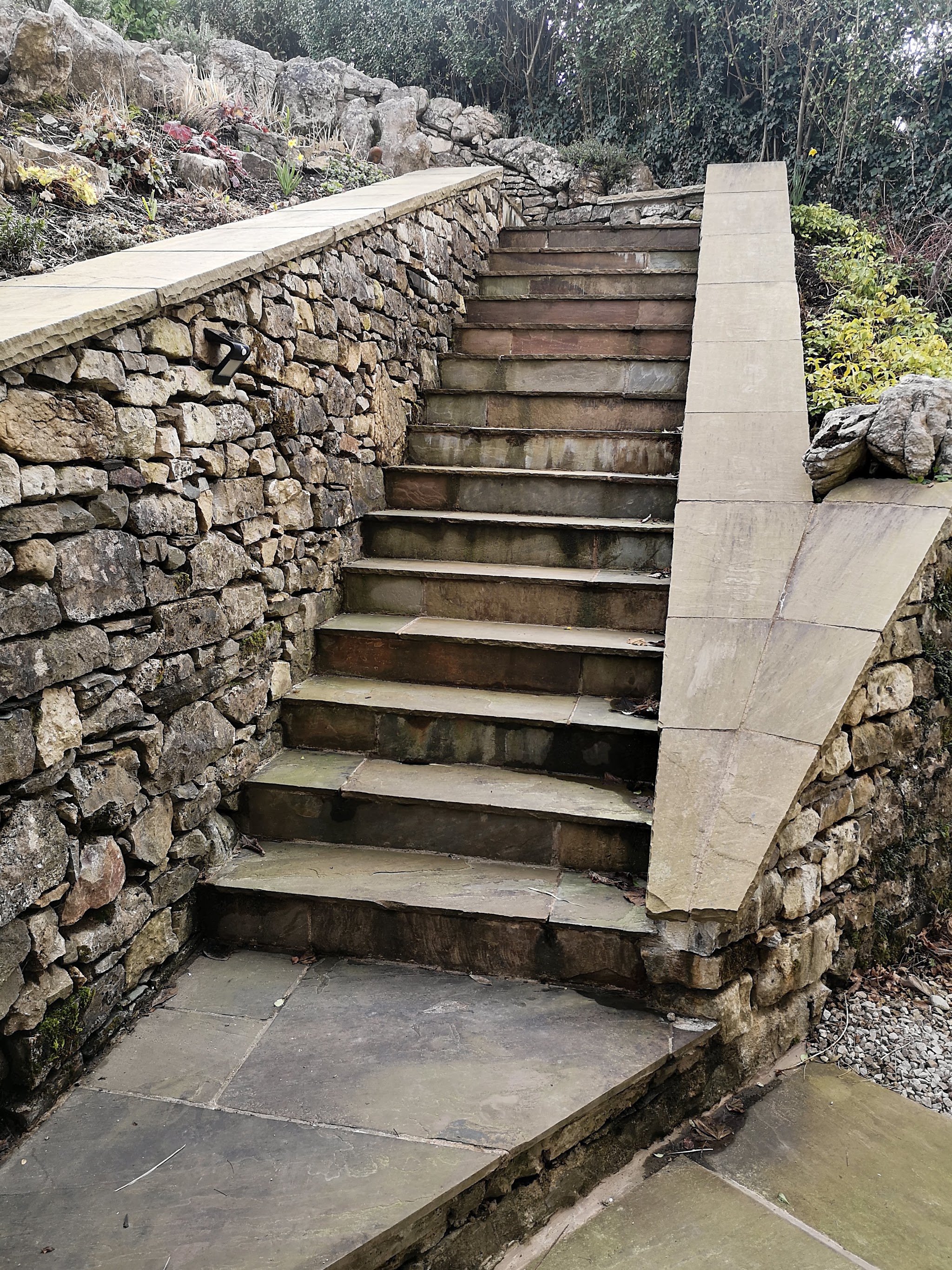 A long flight of stone steps rising between drystone walls