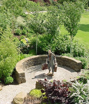 A figure sculpture inside a curved stone seat